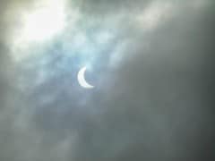 A glimpse of the solar eclipse through cloudy skies.